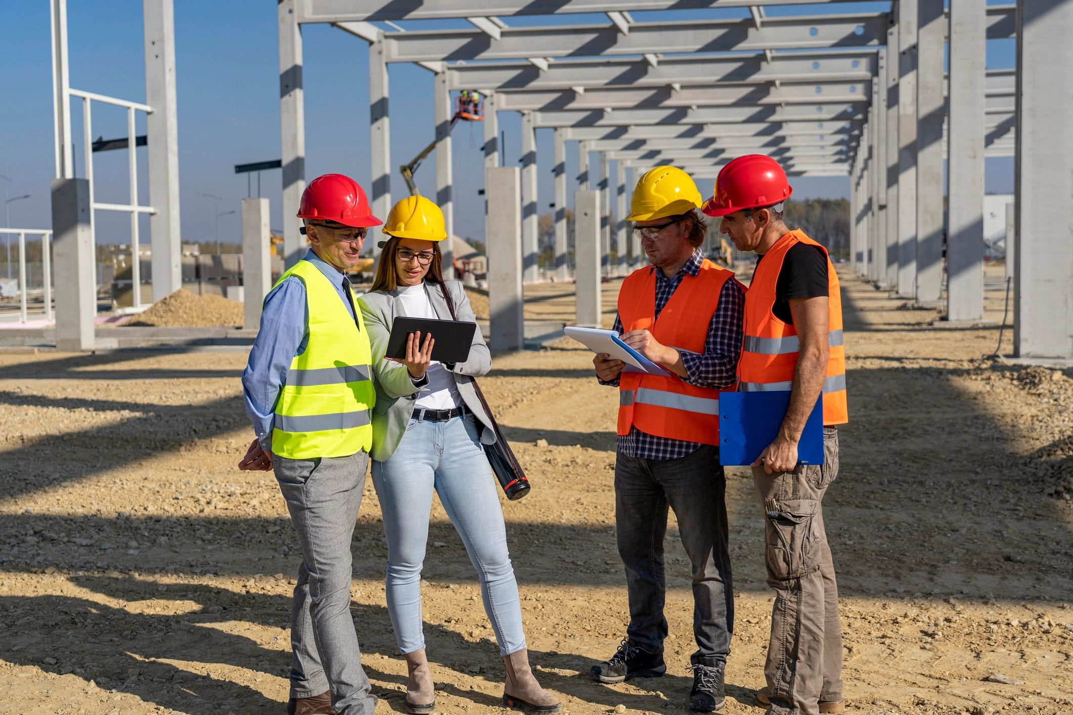 Construction project managers reviewing site plans